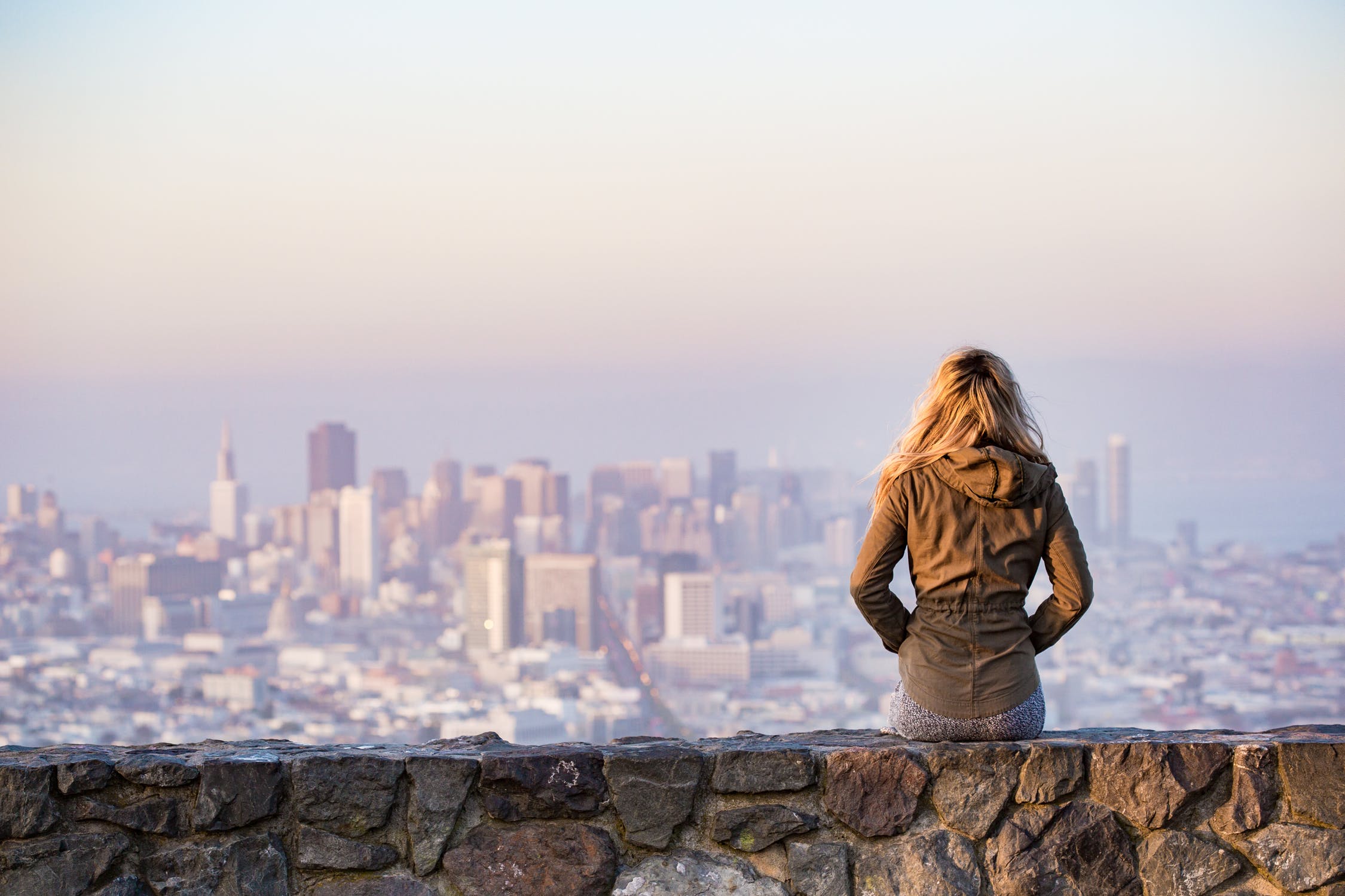 Young woman alone staring at the city