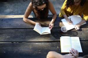 Tribe members reading on a bench