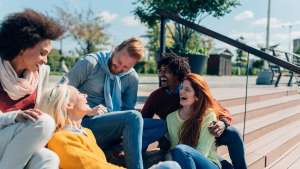 Five friends laughing outside