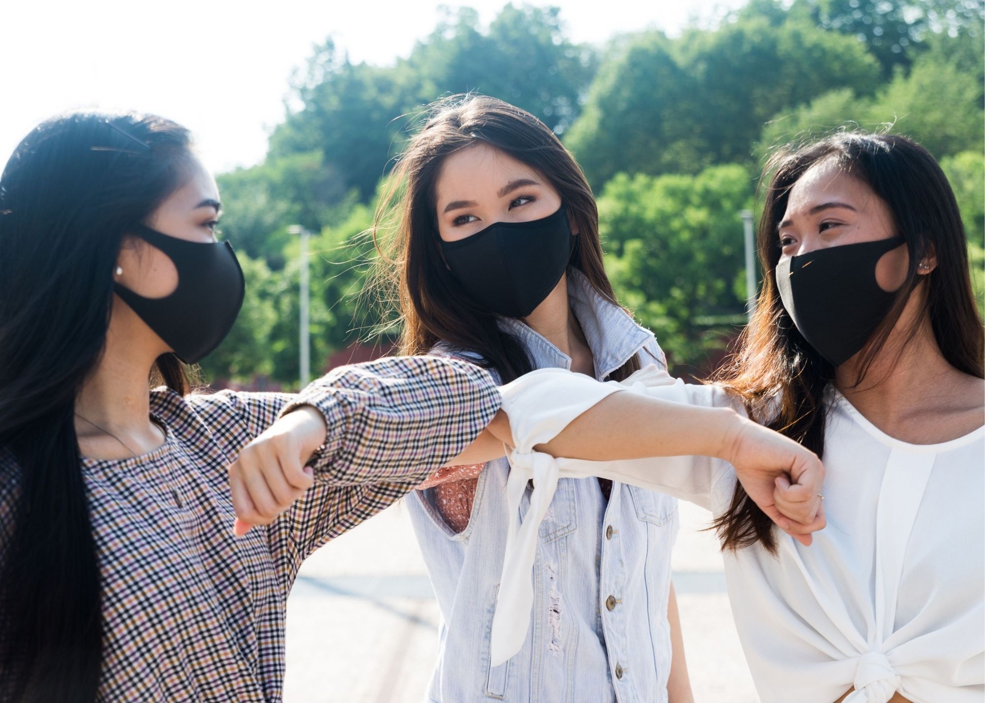 Three friends hanging out and wearing masks during covid-19